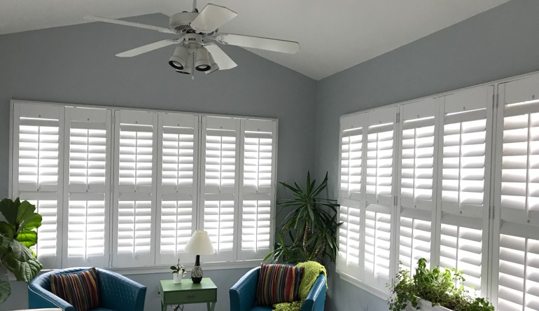 Boise living room with fan and shutters